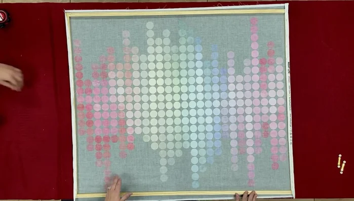 Staple the top and bottom edges of the fabric to the frame, stretching the fabric evenly. Tuck the corners to create a neat finish and staple them securely.