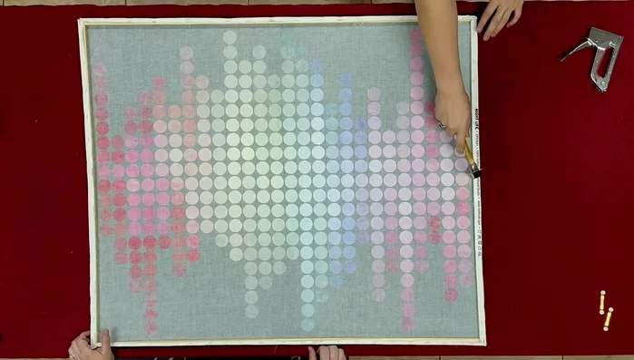 Attach sawtooth picture hangers a couple of inches in from each corner of the frame.