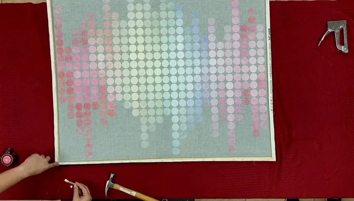 Attach sawtooth picture hangers a couple of inches in from each corner of the frame.