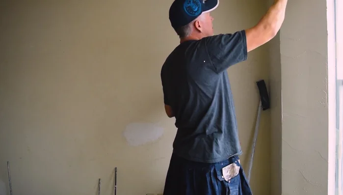 Sand, scrape, and apply a thin skim coat to fill in any remaining bubbles. Then, apply texture.