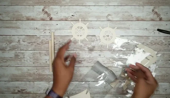 Attach the dowel rod wheels to the cutouts and smooth the edges.