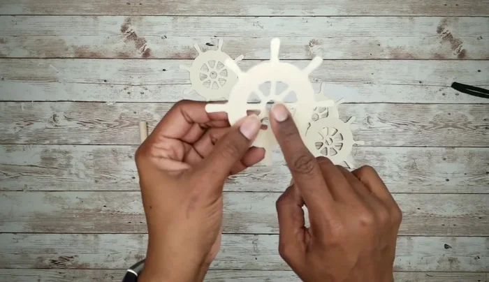 Attach the dowel rod wheels to the cutouts and smooth the edges.