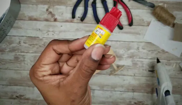 Attach the fork handle to the planter using E6000 and hot glue, covering the prongs with cardstock and hot glue.