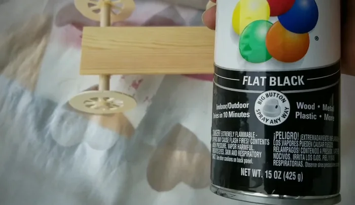 Spray paint the wheel base with flat black paint and let it dry thoroughly.