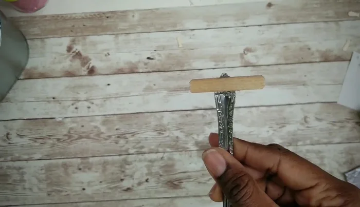 Attach a small piece of craft stick to the fork handle using E6000 and hot glue, then paint it black.