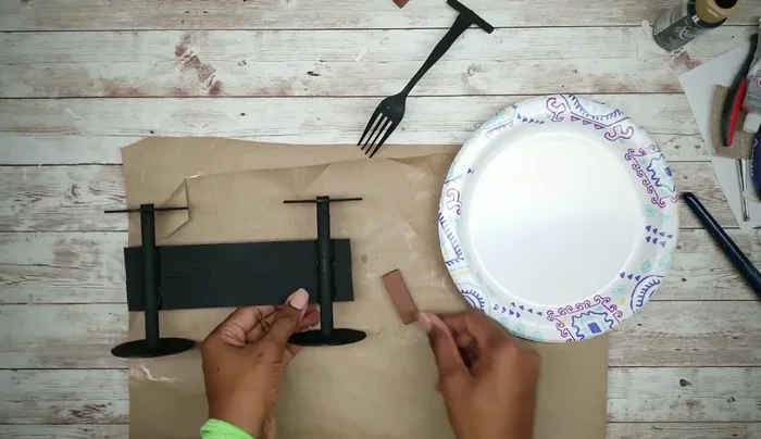 Attach the fork handle to the planter using E6000 and hot glue, covering the prongs with cardstock and hot glue.