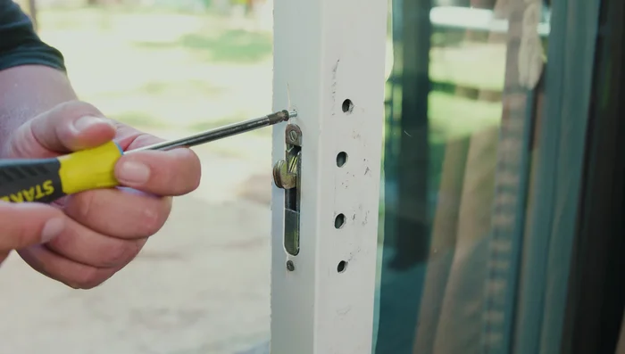 If the latch hook is inside the door, use the locking tab or a flathead screwdriver to get it out.