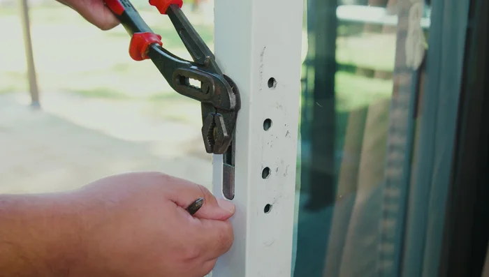 If the latch hook is inside the door, use the locking tab or a flathead screwdriver to get it out.