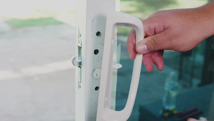 Install the exterior handle using the ping-pong method (tighten one screw slightly, then the other, alternating until secure).