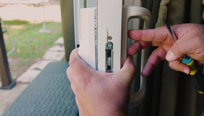 Install the exterior handle using the ping-pong method (tighten one screw slightly, then the other, alternating until secure).