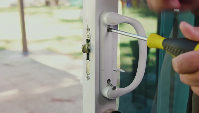 If the latch hook is inside the door, use the locking tab or a flathead screwdriver to get it out.