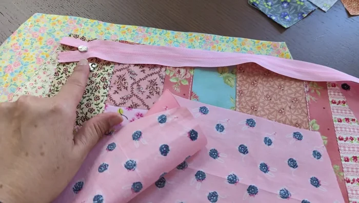 Top stitch the zipper to the bag front and lining.