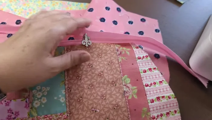 Top stitch the zipper to the bag front and lining.