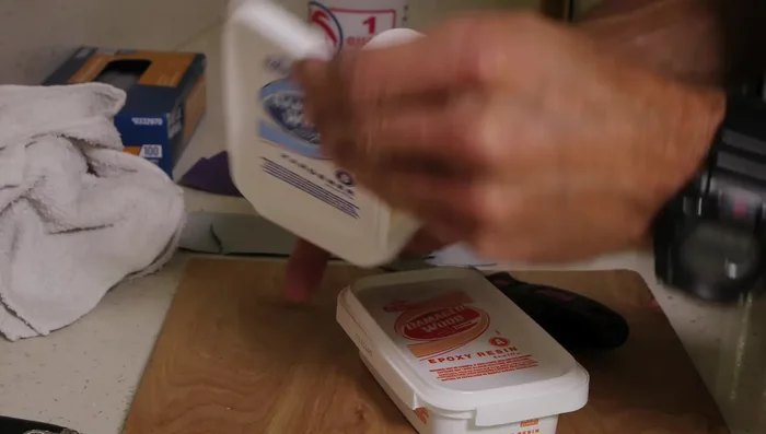 Apply the epoxy to the gouge using a putty knife, filling it as smoothly as possible. Don't worry about perfection, sanding will follow.