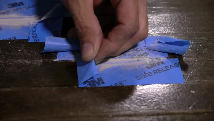 Remove the tape carefully, taking care not to damage the existing finish. Gently sand any remaining hard edges.