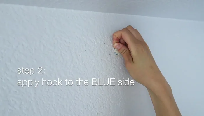 Remove the liner on the blue side of the hook.