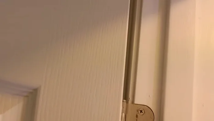 Assess the door's alignment: Observe gaps at the top and bottom of the door on both sides. Uneven gaps indicate the need for alignment.