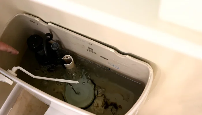Flush the toilet to remove as much water from the tank as possible.