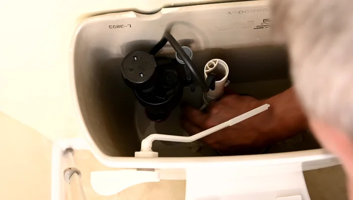 Install the new flapper by hooking it onto the flush arm and securing it in place.