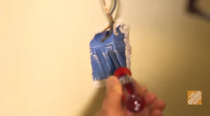 Feed Romex cable: Run Romex cable through the hole, leaving about a foot on each side.