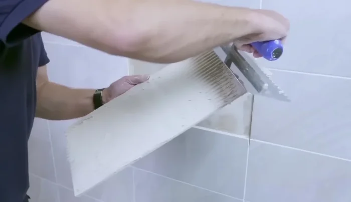 Use tile spacers to maintain even grout lines (126.079).