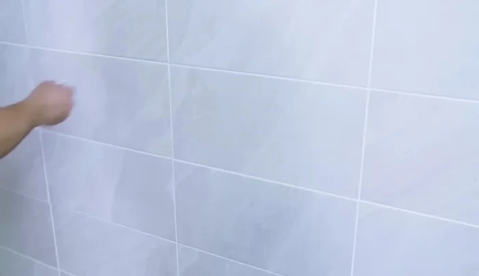 After the grout has dried, buff the surface to remove residue (160.8).