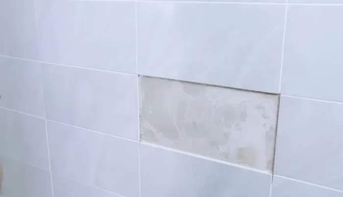 Use tile spacers to maintain even grout lines (126.079).
