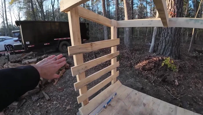 Attach side slats to prevent firewood from rolling out.