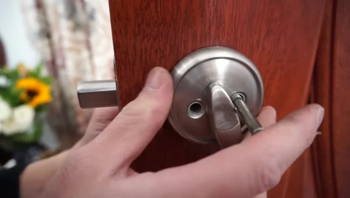 Hand-tighten the bolts, ensuring the 'lock' marking is at the top. Do not fully tighten yet; this allows for adjustment.