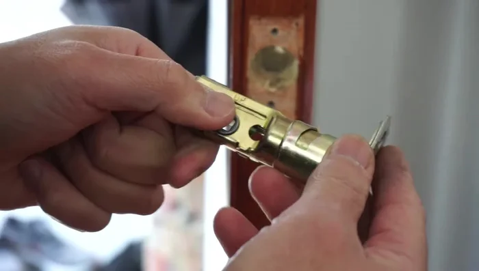 Hand-tighten the bolts, ensuring the 'lock' marking is at the top. Do not fully tighten yet; this allows for adjustment.
