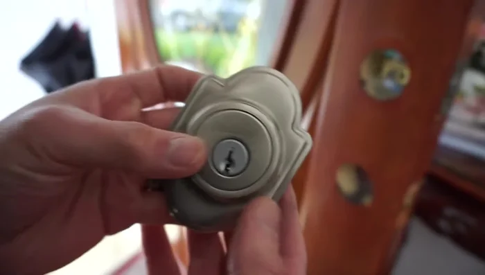 Hand-tighten the bolts, ensuring the 'lock' marking is at the top. Do not fully tighten yet; this allows for adjustment.