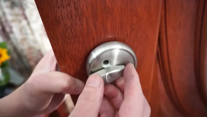 Hand-tighten the bolts, ensuring the 'lock' marking is at the top. Do not fully tighten yet; this allows for adjustment.