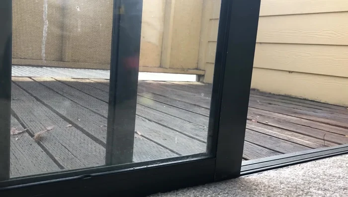 Using a rubber mallet and a block of wood (to protect the frame), gently tap the back of the rail to remove it from the glass.