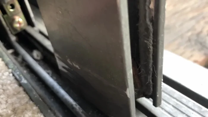 Gently tap the frame back onto the glass using a rubber mallet and a block of wood.