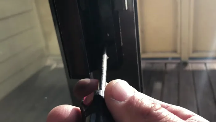 Using a rubber mallet and a block of wood (to protect the frame), gently tap the back of the rail to remove it from the glass.