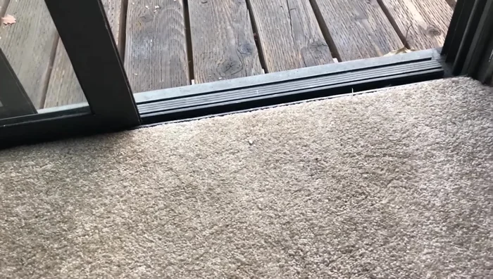 Using a rubber mallet and a block of wood (to protect the frame), gently tap the back of the rail to remove it from the glass.