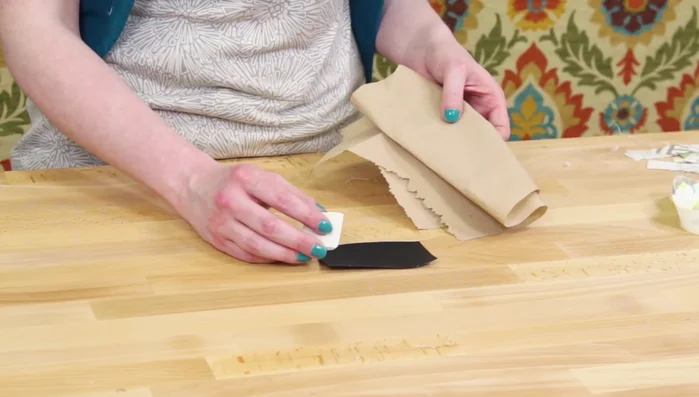 Prepare chalk cloth label: Rub chalk on, wipe off, repeat to achieve desired color and texture. Cut and glue to cover the original label.