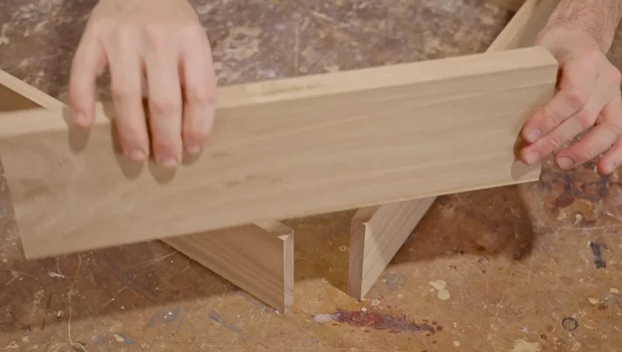 Cut grooves in both sides of each joint to create a spline joint. This strengthens the cabinet.