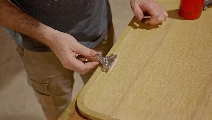 Attach hinges to the door and cabinet.