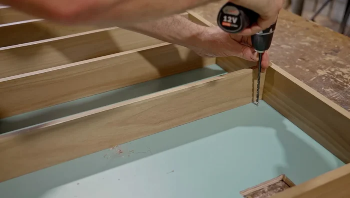 Install the cabinet into the bathroom using stainless steel screws and a diamond drill bit for the tiles.