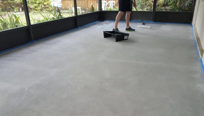 Apply the first coat of sealer using an 18-inch roller, ensuring even coverage.