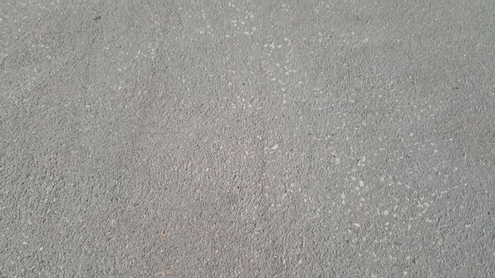 Clean the concrete surface thoroughly with a pressure washer and allow it to dry completely.