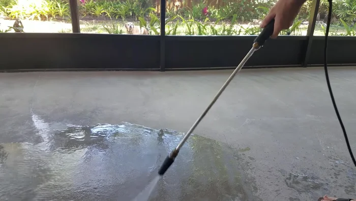 Clean the concrete surface thoroughly with a pressure washer and allow it to dry completely.