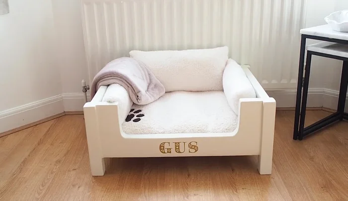 Assemble the bed with the mattress and custom-made cushions.