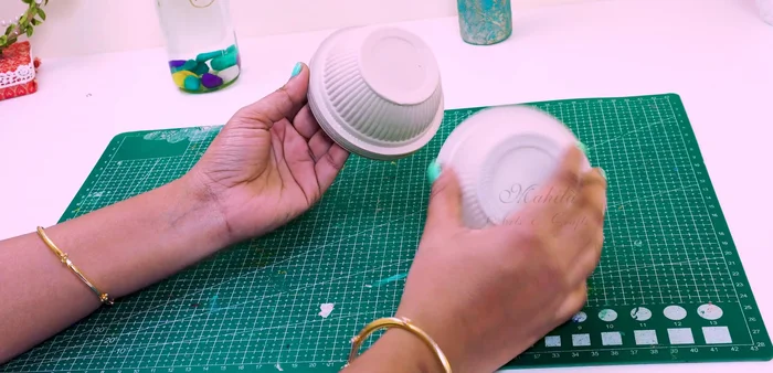 Make a hole in the top of the cup and insert a craft cylinder/PV pipe.