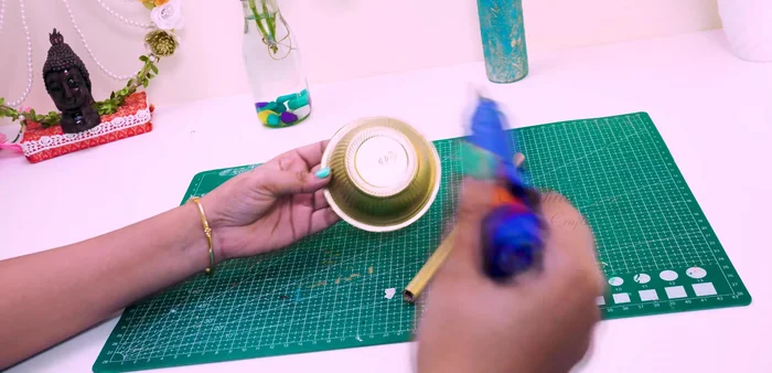 Make a hole in the top of the cup and insert a craft cylinder/PV pipe.