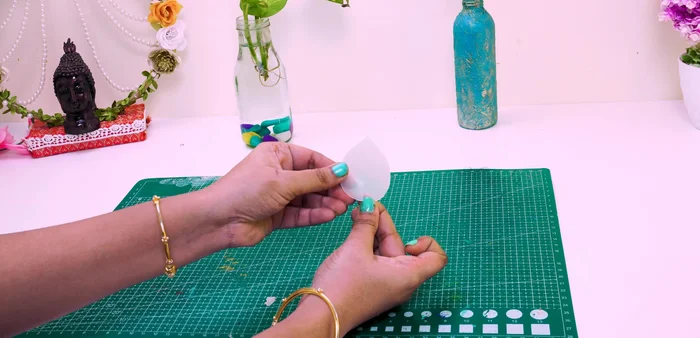 Cut half an inch in the middle of the large petals and stick them together with glue to create a folded effect.