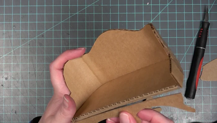 Cut and roll the arm pieces (single layer chipboard). Glue the rolled portions to the couch.