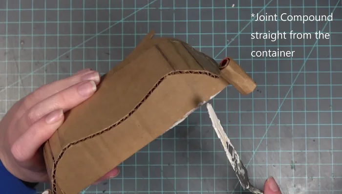 Apply a mixture of Elmer's glue and joint compound to the couch for a smooth, solid finish. Sand again.