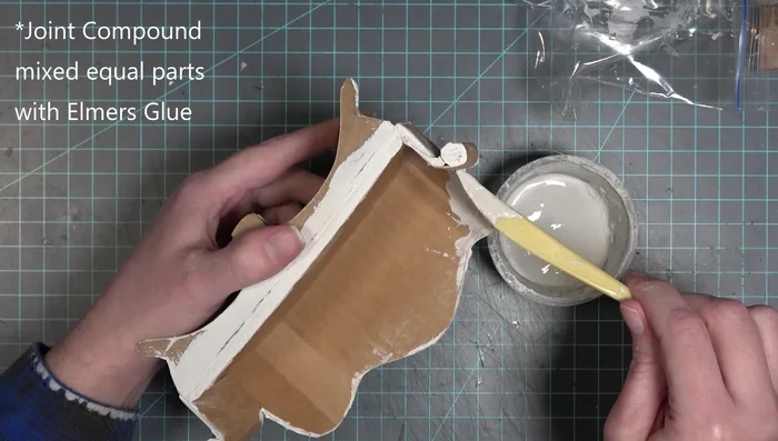 Apply a mixture of Elmer's glue and joint compound to the couch for a smooth, solid finish. Sand again.